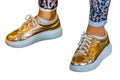 Golden sneakers and leopard prints leggings Royalty Free Stock Photo