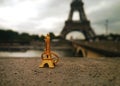 Golden souvenir - a miniature Eiffel Tower infront of the real thing