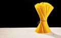 Bunched spaghetti on table with black copy space