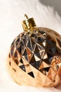 Golden sparkling ball christmas ornament on white background