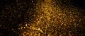 Golden sparks, Christmas and New Year glittering stars swirl on black bokeh background, backdrop with sparkling gold