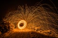 Golden sparks fly at night in winter snow through glowing steel wool spun in a circle, Germany Royalty Free Stock Photo