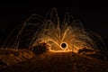 Golden sparks fly at night in winter snow through glowing steel wool spun in a circle, Germany Royalty Free Stock Photo