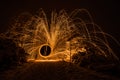 Golden sparks fly at night in winter snow through glowing steel wool spun in a circle, Germany Royalty Free Stock Photo