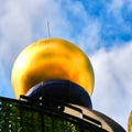 Golden sphere on the Green Citadel, a large residential building, commercial building and hotel designed by the artist