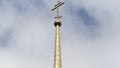 Golden spire of an Orthodox church against the sky. Stock footage. Bottom view of a long shining spire with a cross of a Royalty Free Stock Photo