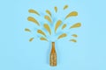 Golden splashing Champagne bottle on blue background