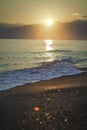 Golden splashing foamy sea waves at sunset sky