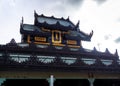 The golden square hall with a pyramidal roof castle mondop and golden tiered umbrella under the blue sky