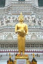 Golden standing Buddha at main Prang of Wat Arun Ratchawararam Ratworamahawihan Temple of Dawn . Royalty Free Stock Photo