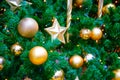 Golden star and baubles hanging as decorations on a Christmas tree, close-up Royalty Free Stock Photo