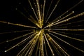 Golden star burst light pattern against a black background Royalty Free Stock Photo