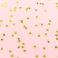 Golden star sprinkles on pink. Festive holiday background. Celeb Royalty Free Stock Photo