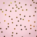 Golden star sprinkles on pink. Festive holiday background. Celeb Royalty Free Stock Photo