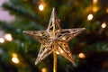 Golden Star Tree Topper Shines Bright on Christmas Tree at Night Royalty Free Stock Photo