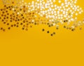 Golden stars confetty on yellow background Royalty Free Stock Photo