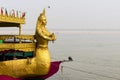 Golden Statue Atop a Boat in the Ganges River, India - Varanasi