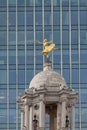 Golden statue of a ballet dancer on top of Victoria Palace Theatre in London