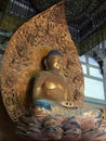 Golden statue of Buddha sitting on lotus in Byodo-in Temple in Oahu, Hawaii Royalty Free Stock Photo