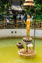 Golden statue of Buddha and the World Peace Pond at Monkey temple Swayambhunath Stupa, Kathmandu, Nepal.