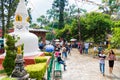 Golden statue of Buddha and the World Peace Pond at Monkey temple Swayambhunath Stupa, Kathmandu, Nepal. Local vendor exchanging m