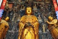 Golden Statue of Guanyin and Sudhana acompanied by their masters from the Jade Buddha Temple interior in Shanghai