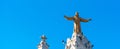 Golden Statue of Jesus Christ on the facade of the Temple of the Sacred Heart of Jesus, Barcelona, Catalonia, Spain. Isolated on Royalty Free Stock Photo