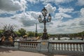 Golden statue and lighting post adorning the Alexandre III bridge over the Seine River and Eiffel Tower in Paris. Royalty Free Stock Photo