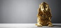 Golden statue of lion, a sculpture. Concept of a strength, power