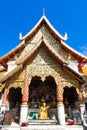 Golden statue of a monk place at the temple facade