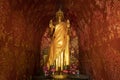 Golden statue of a standing Buddha in Wat Xieng Thong temple in Luang Prabang, Laos