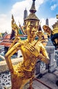 Golden statue at Temple of Emerald Buddha Wat Phra Kaew in Grand Royal Palace. Bangkok, Thailand Royalty Free Stock Photo