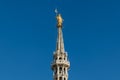 Golden statue of Virgin Mary, placed at the rooftop of Duomo cathedral in Milan, Italy Royalty Free Stock Photo