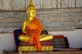 Golden Statute of buddha sitting with orange robe in monastery Luang Prabang, Lao