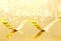 Golden Streamer on shiny background. Holiday background or greet