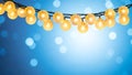 Golden string lights on a blue bokeh background, copy space Royalty Free Stock Photo