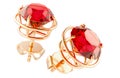 Golden stud earrings with red gems. Ruby, rhodolite or garnet. 3D rendering Royalty Free Stock Photo