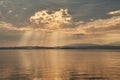 Sunset at lake Garda in Italy, golden sun behind clouds, Sirmione Royalty Free Stock Photo