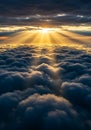 Golden sun rays break through dark, thick clouds, creating a dramatic contrast. The Royalty Free Stock Photo