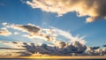 Golden Sun Rays Breaking Through Dramatic Clouds Over a Calm Ocean Horizon at Sunset Royalty Free Stock Photo