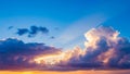 Golden Sun Rays Breaking Through Dramatic Sunset Clouds Over a Vibrant Horizon with Deep Blue Sky Royalty Free Stock Photo