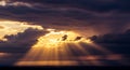 Golden Sun Rays Piercing Through Dramatic Dark Clouds Royalty Free Stock Photo