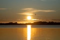 Golden sun rising above horizon with three gulls blurred flying Royalty Free Stock Photo