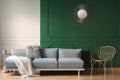 sun shape like mirror on green wall of living room interior with scandinavian sofa with pillows Royalty Free Stock Photo