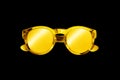 Golden sunglasses black background isolated close up, gold metallic sunglass, shiny yellow metal sun glasses, luxury accessory Royalty Free Stock Photo