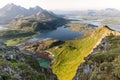 Golden sunlight bathes the verdant valleys and turquoise inlets of the Lofoten Islands, Norway Royalty Free Stock Photo