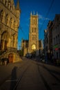 The golden sunlight falling on the tall belfry tower in Ghent, B