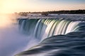 Golden sunlight illuminating a powerful dramatic waterfall flowing quickly. Niagara Falls