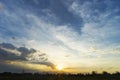 Golden sunrise and blue sky over silhouette of residential community houses and park, large skyscape with space for text