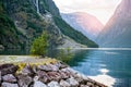 Golden sunrise in the mountains, Gudvangen Norway with reflection in the water of the fjord. Royalty Free Stock Photo